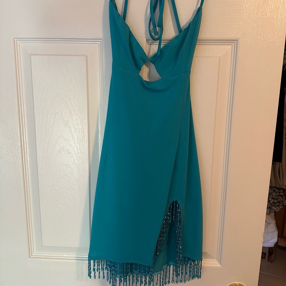 Meshki mini dress with side slit and beading.